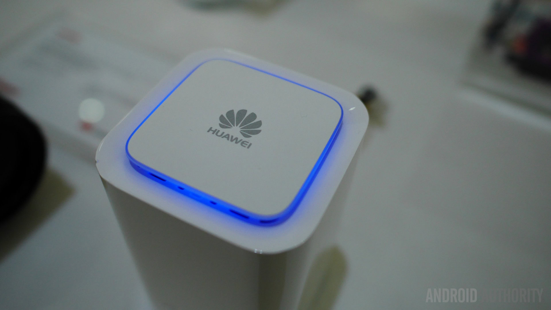 The HUAWEI logo surrounded by a blue light. 