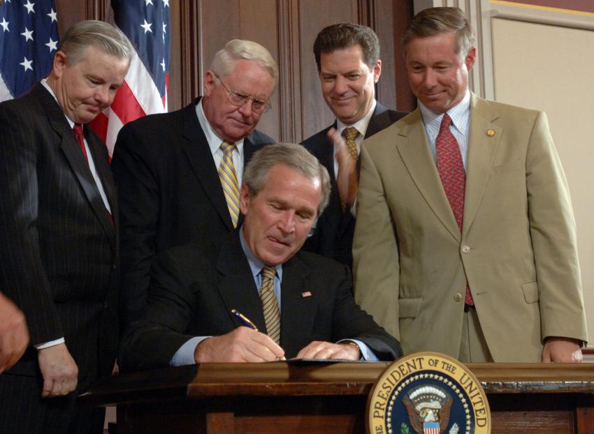 Fred Upton (Right) watching President Bush sign the Broadcast Decency Enforcement Act.
