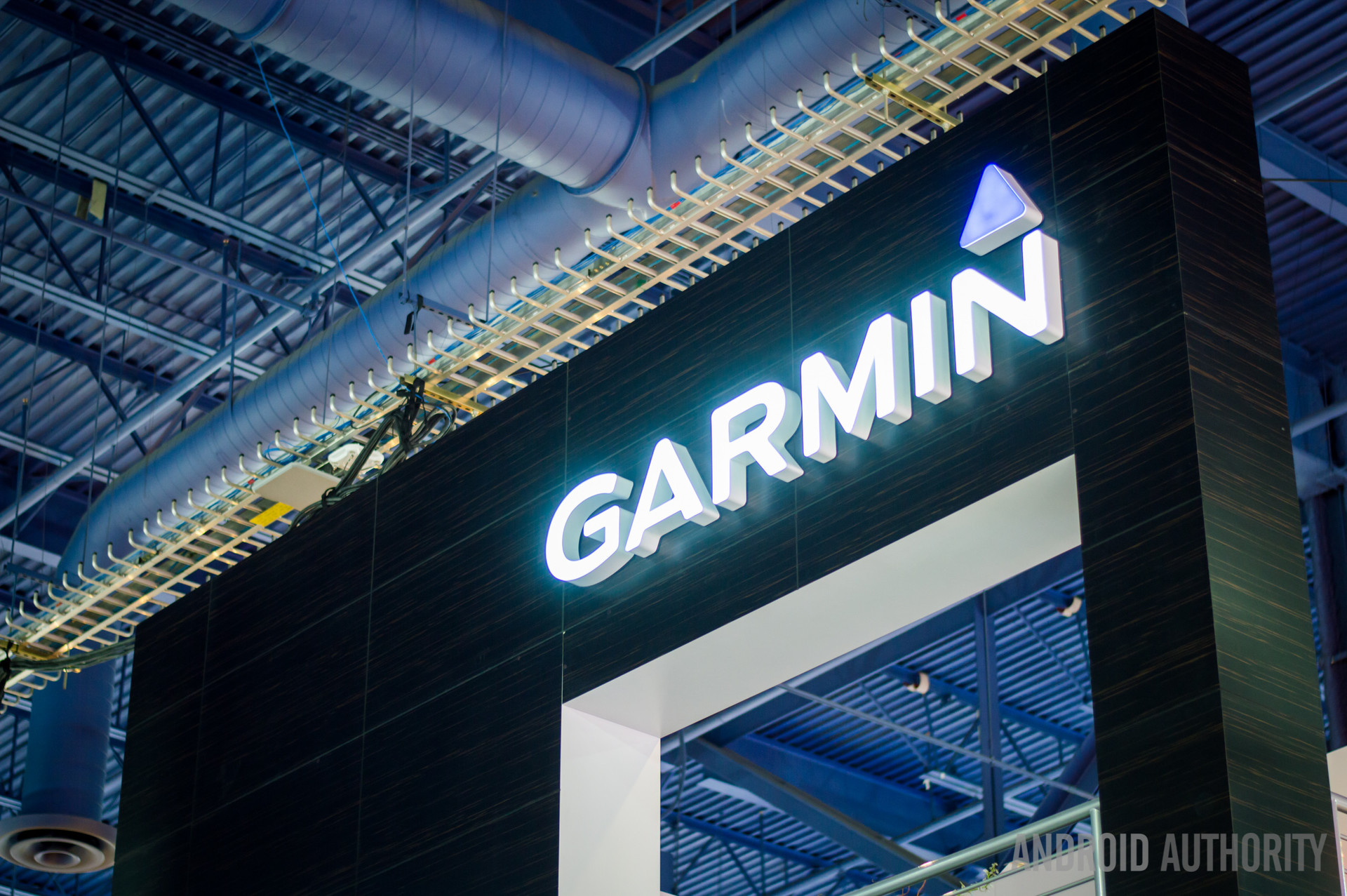 An illuminated Garmin logo shines above an entryway.