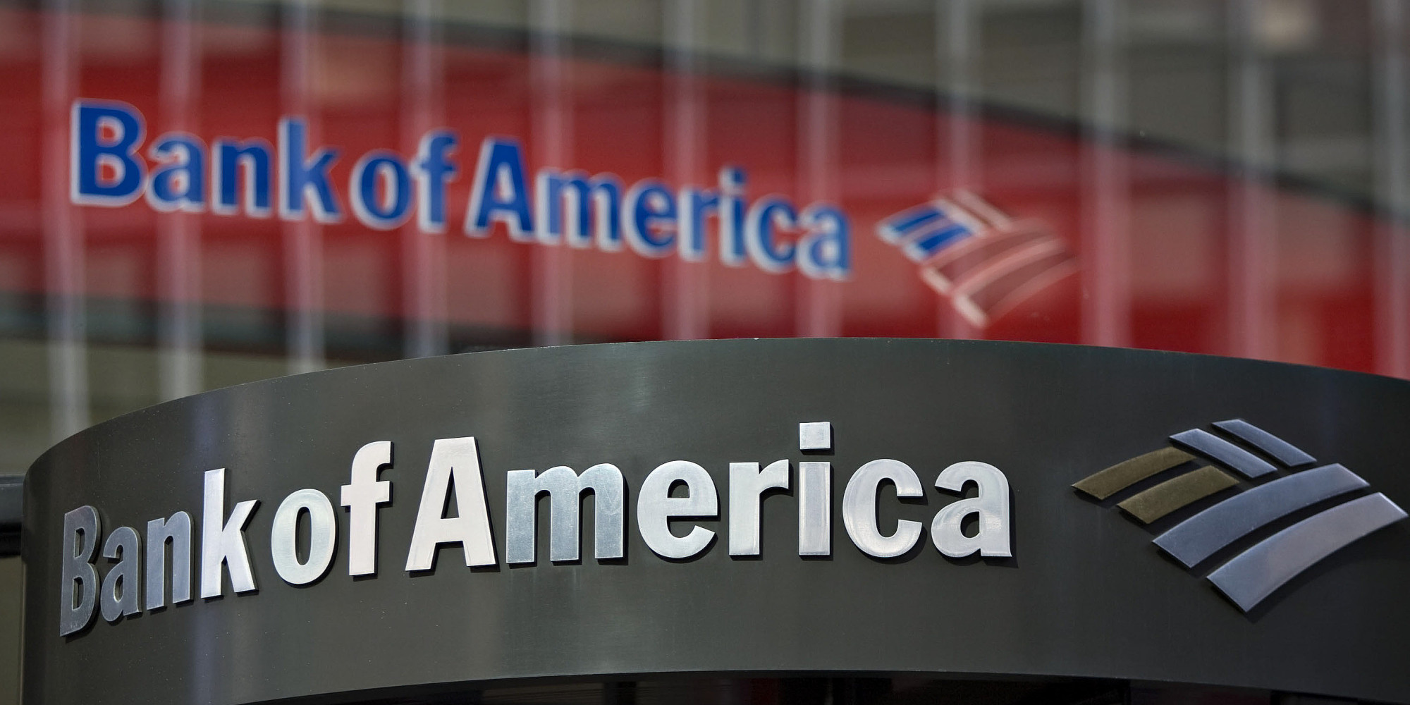 UNITED STATES - FEBRUARY 23:  A Bank of America logo hangs above a bank branch entrance in New York, U.S., on Monday, Feb. 23, 2009. Citigroup Inc. and Bank of America Corp., two of the three biggest U.S. banks, climbed in New York trading after regulators said they may give lenders more capital to revive the banking system.  (Photo by Jin Lee/Bloomberg via Getty Images)