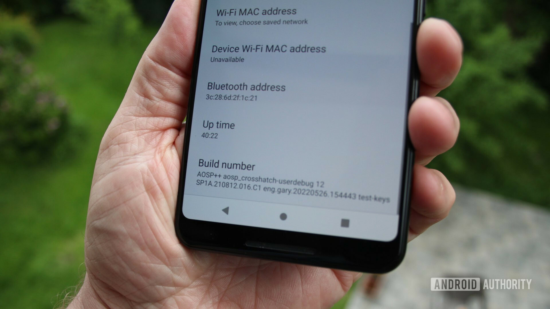 Pixel 3 XL in hand running AOSP showing custom build number