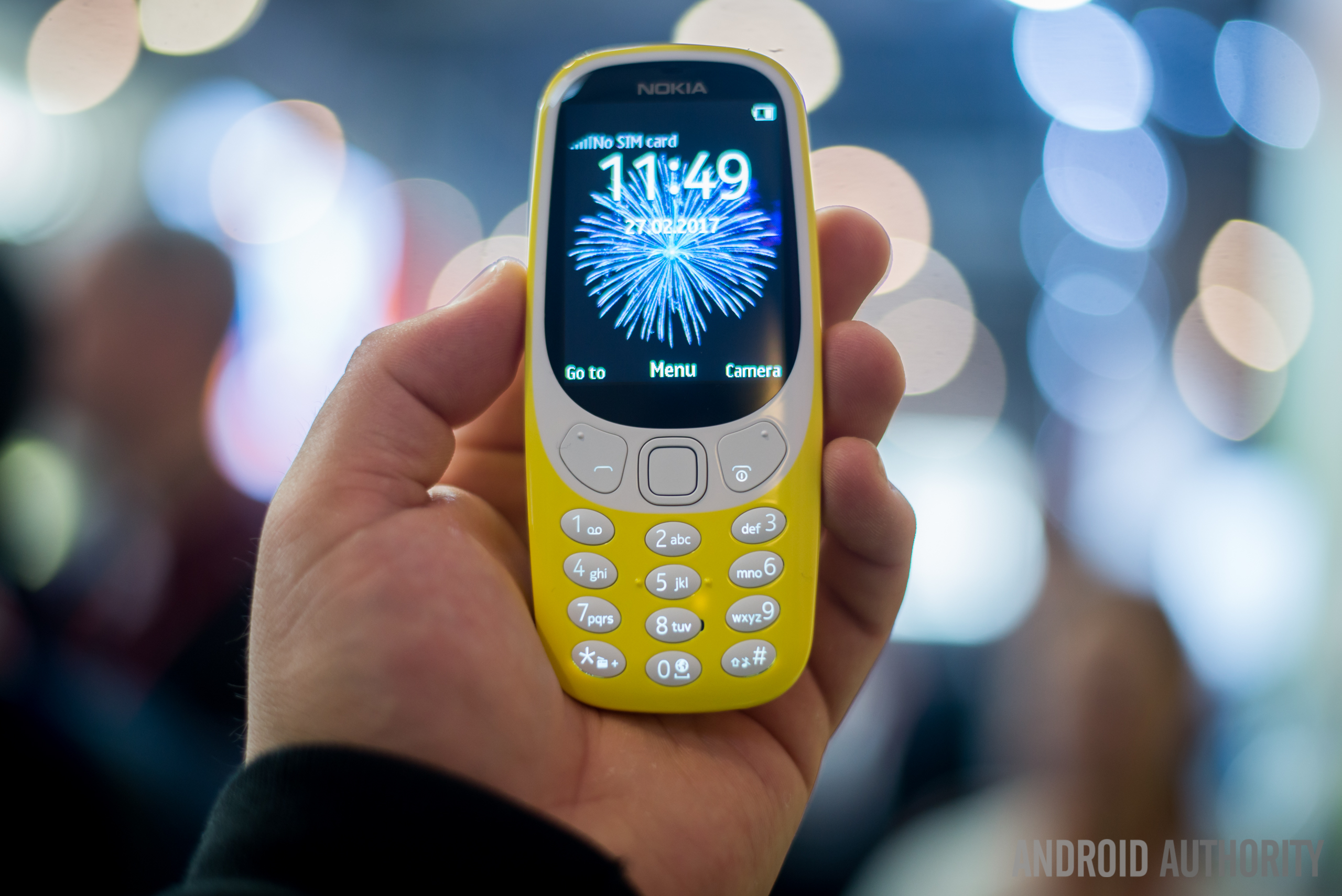 Front side of the new Nokia 3310 held in hand with the display turned on.