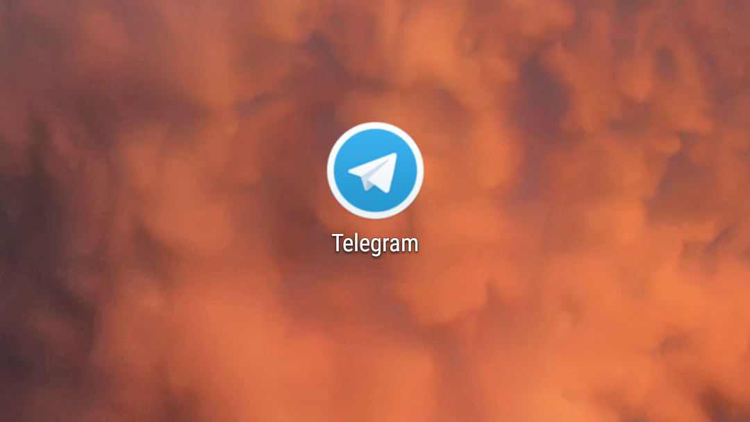 The Telegram app logo on a smokey red background.
