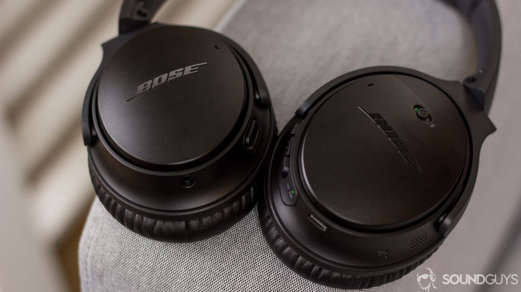 The Bose QuietComfort 35 II noise-cancelling headphones sit on a couch arm.