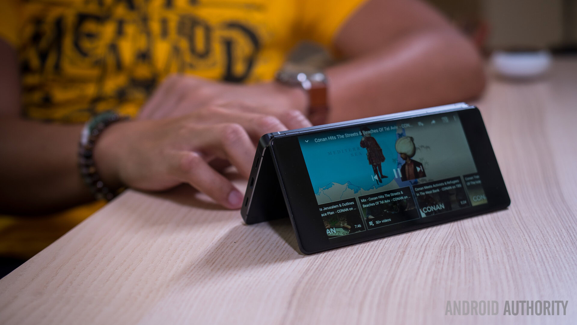 The ZTE Axon M resting on a table in a tent position. 