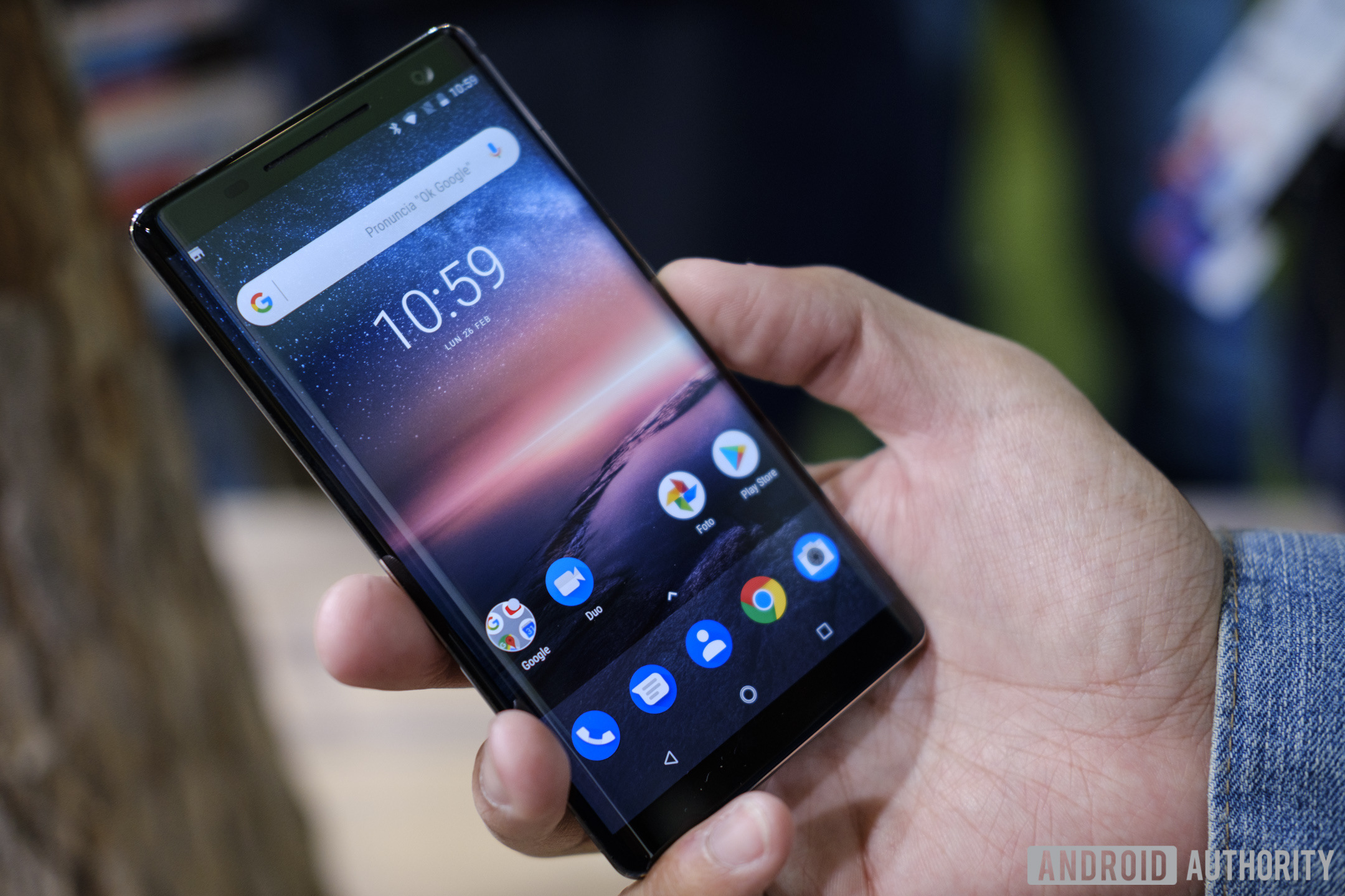 Frontside of the Nokia 8 Sirocco held in hand with a display turned on