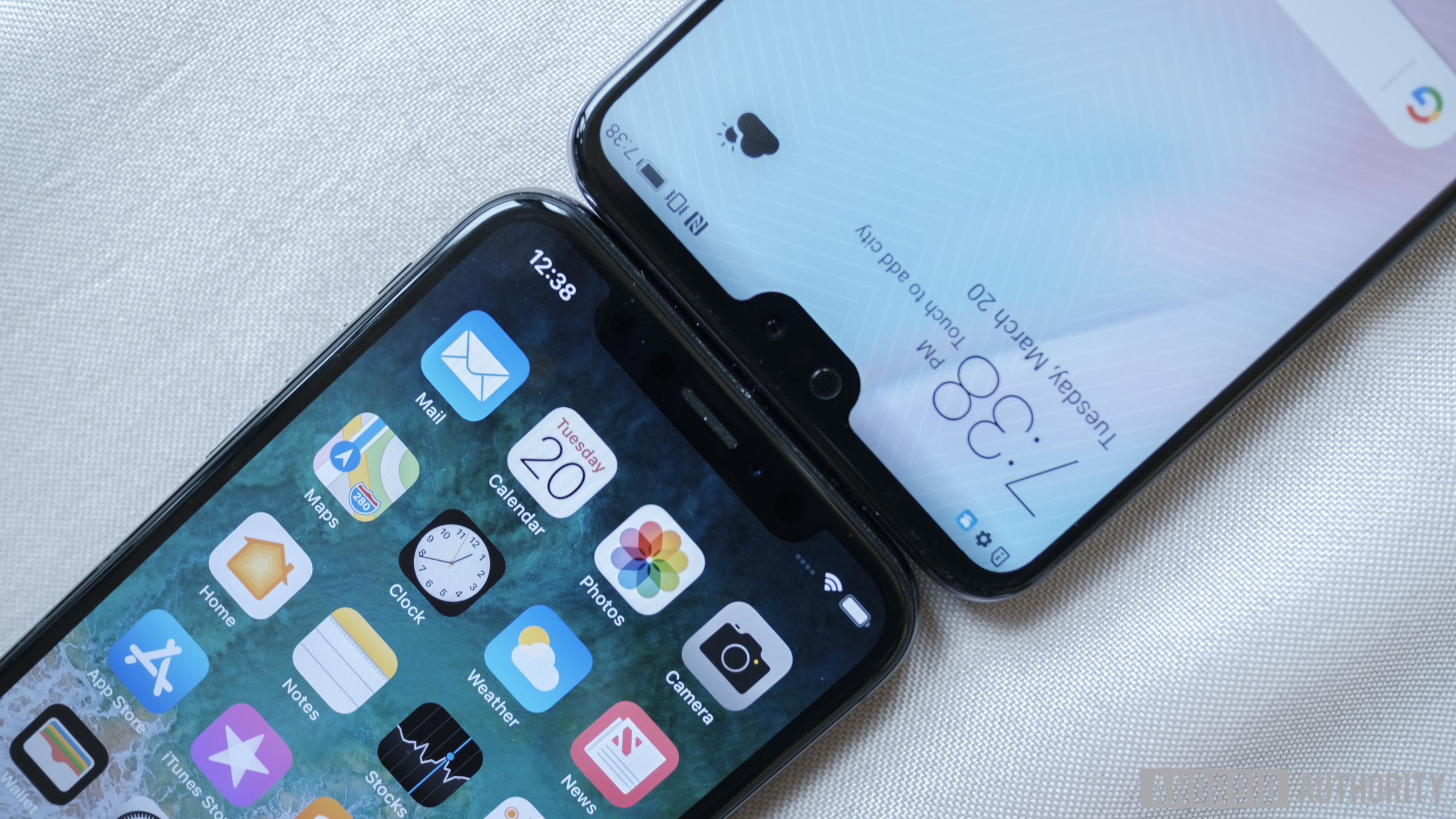 The Huawei p20 Pro and Apple iPhone X touching each other on a table.