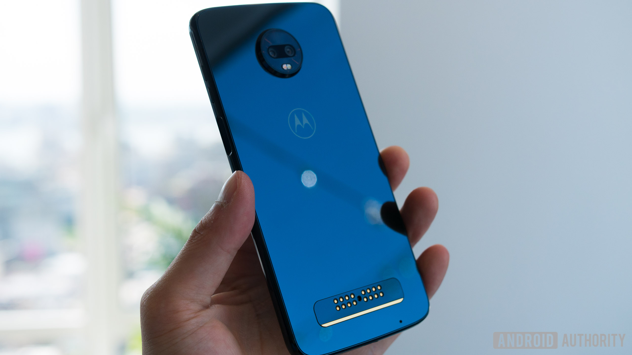 Moto Z3 Play smartphone in blue in a person's hand. 
