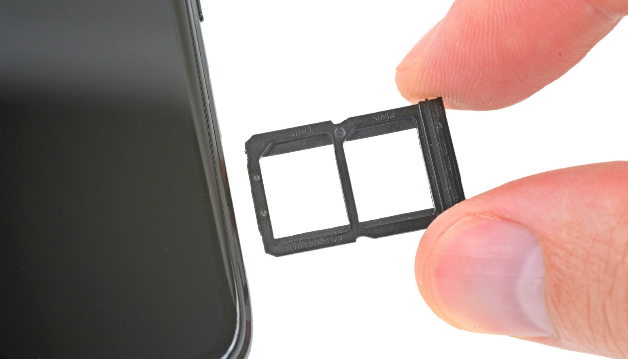 A closeup of the SIM card tray seen during a OnePlus 6 teardown.