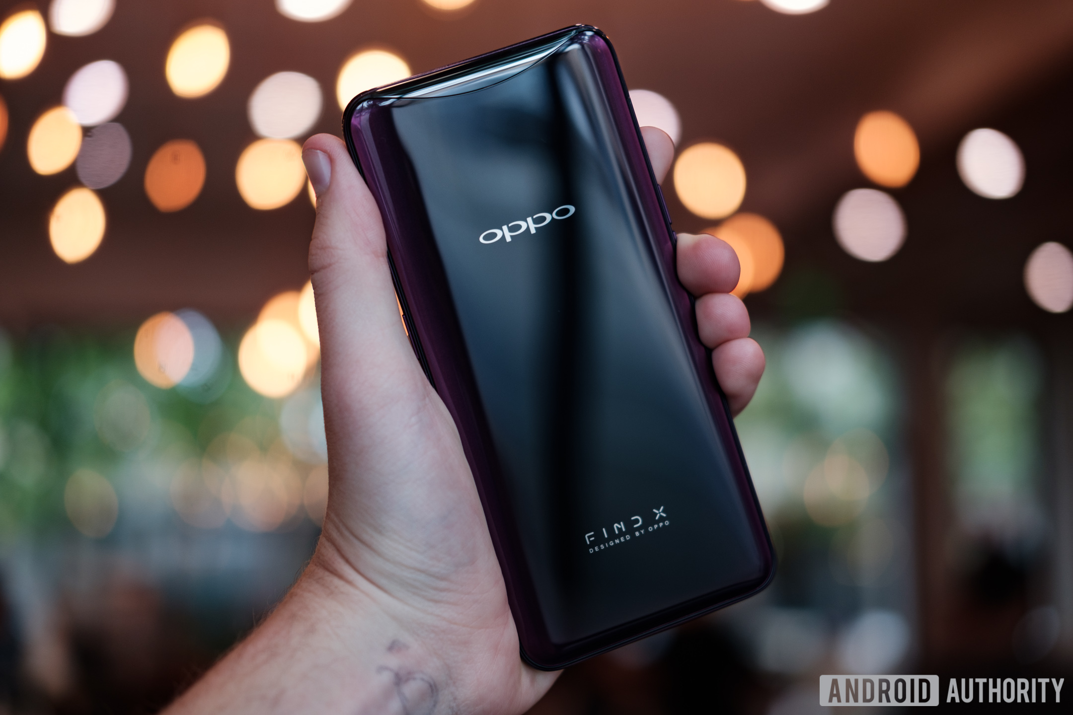 black oppo find x held in hand