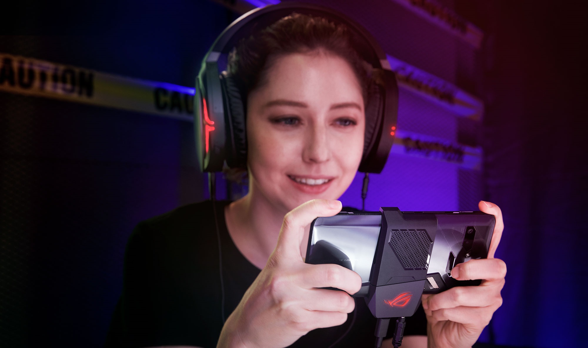 ASUS Rog Phone gaming smartphone in hands from behind in half case.