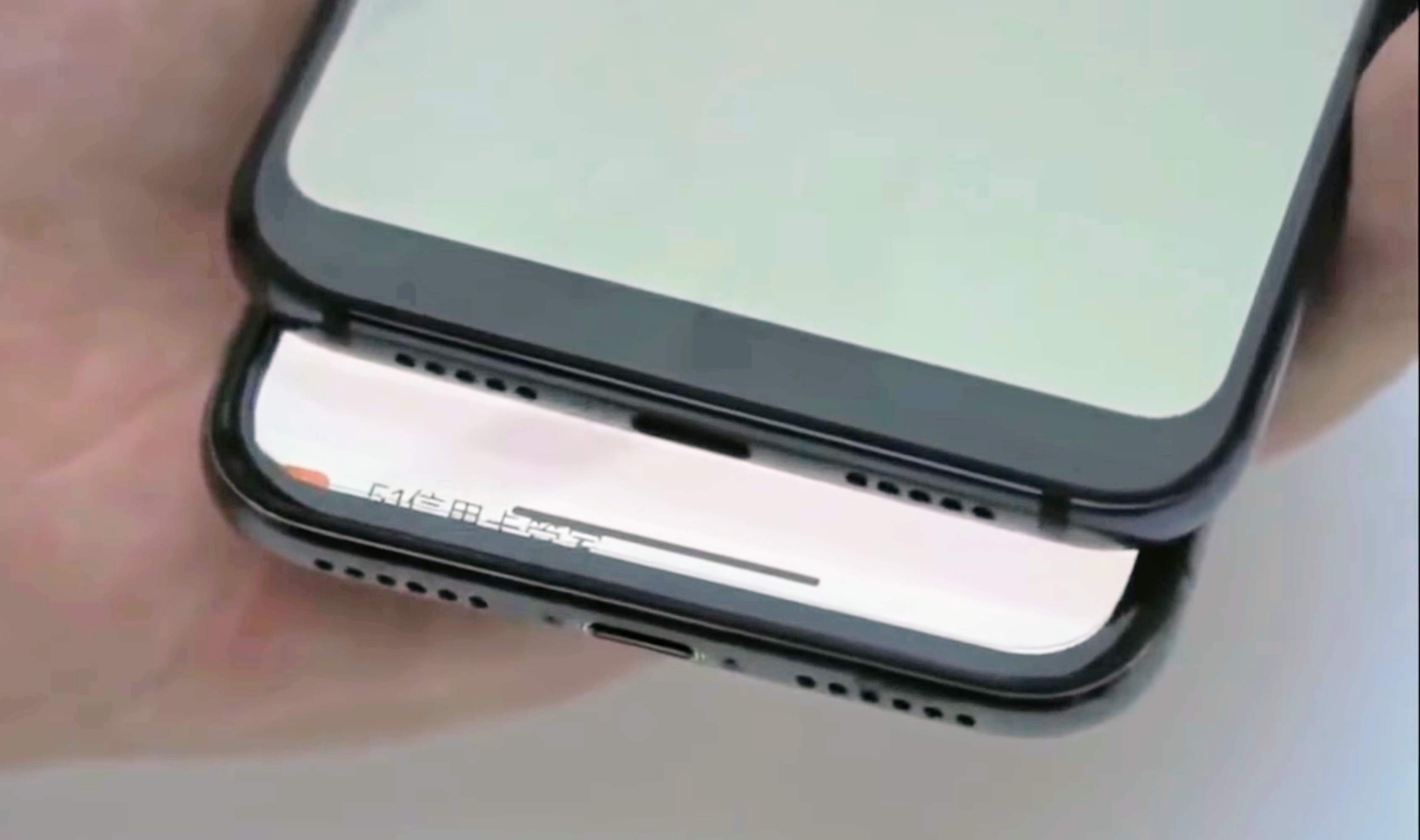 The Xiaomi Mi 8 explorer edition and the iPhone X on top of each other and showing the speaker grill.