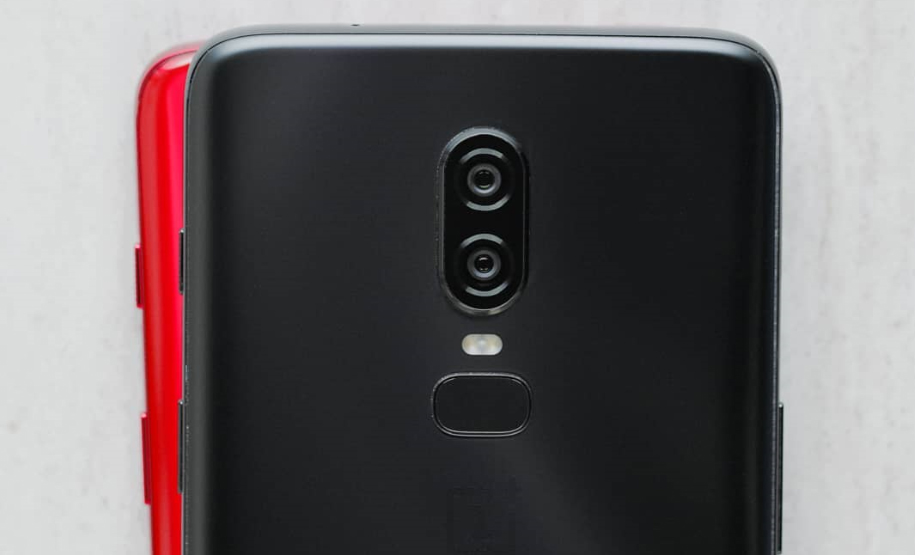 An image that is likely a red OnePlus 6 underneath a black OnePlus 6.