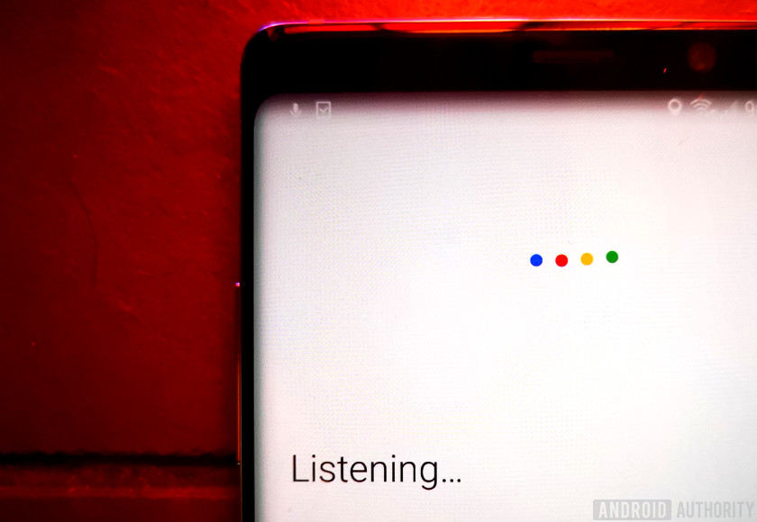 Google Assistant displaying listening text on a red background