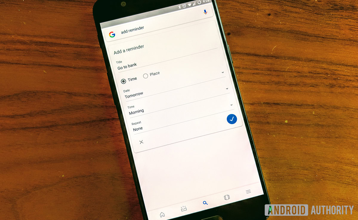 A photo of a phone in the process of setting up Google reminders.