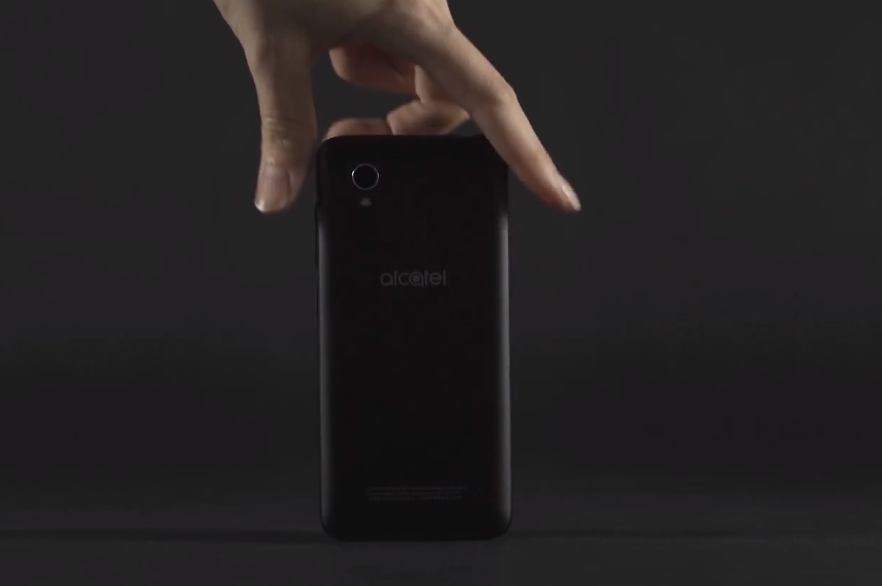 An image of a hand picking up an Alcatel 1 smartphone.