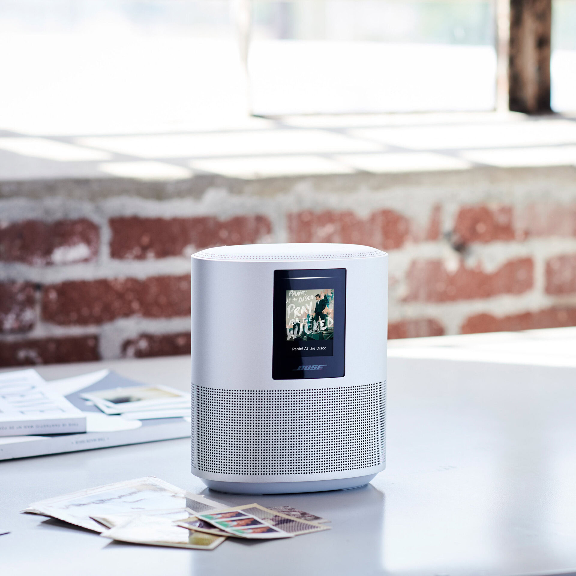 Bose smart speaker soundbars: A product image of the Bose Home Speaker 500 from the Bose press release. The speaker rests on a white table with a bit of clutter in the background.