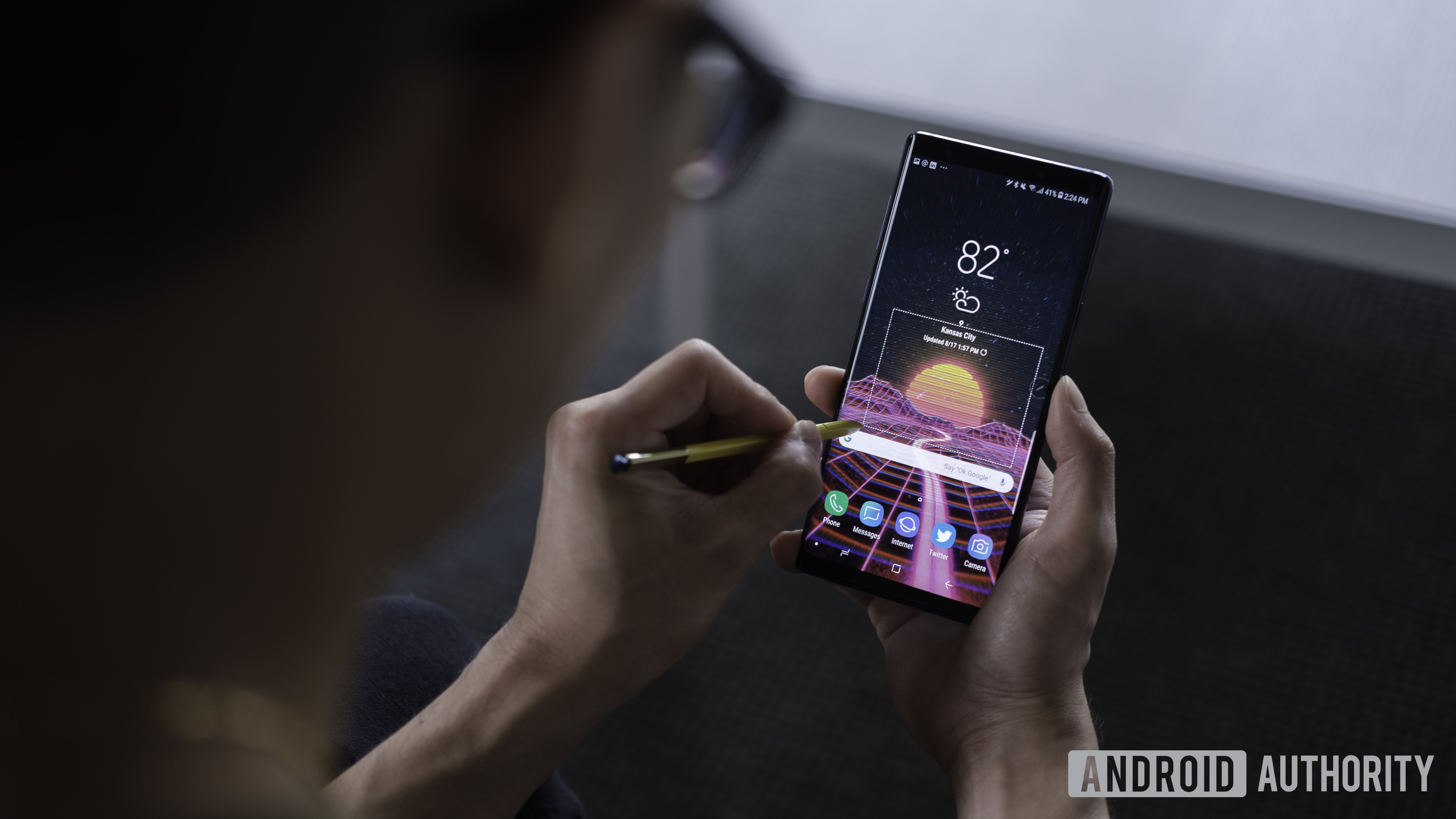 A photo of a man using the Samsung Galaxy Note 9, one of the best phones for power users. 