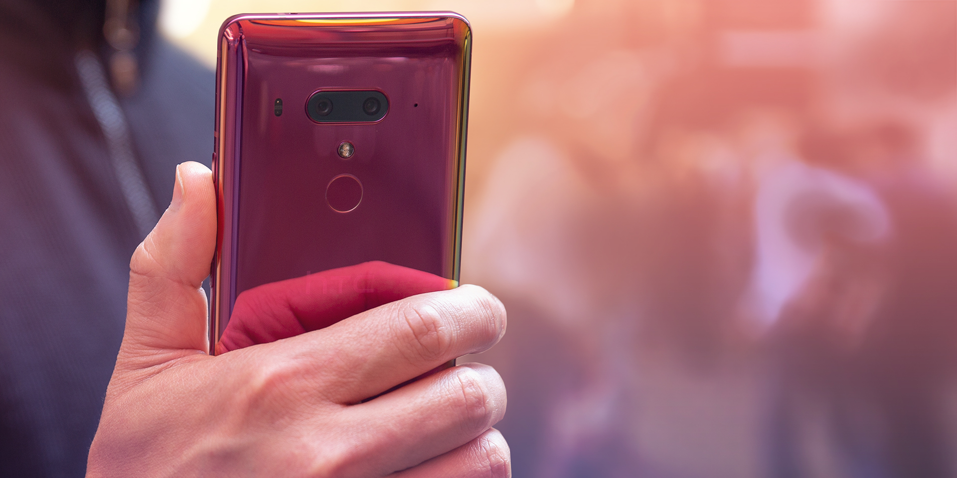 An image of a hand holding an HTCU12 Plus Flame Red edition.