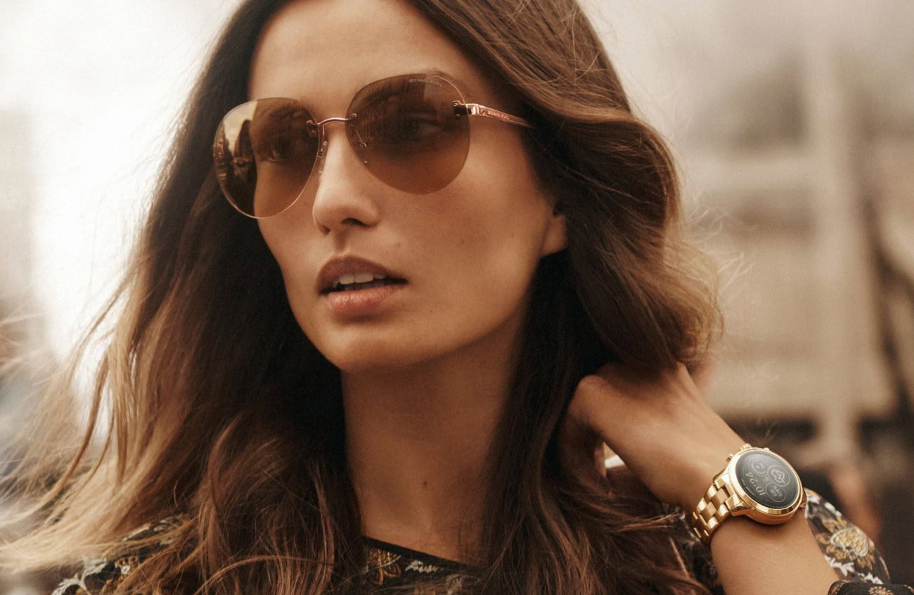 An image of a fashion model wearing a Michael Kors smartwatch.