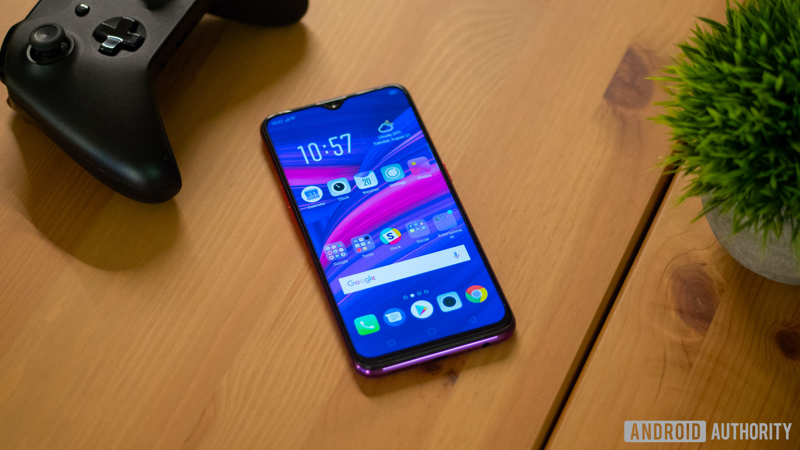 Front side of the OPPO F9 layed on a wooden table.
