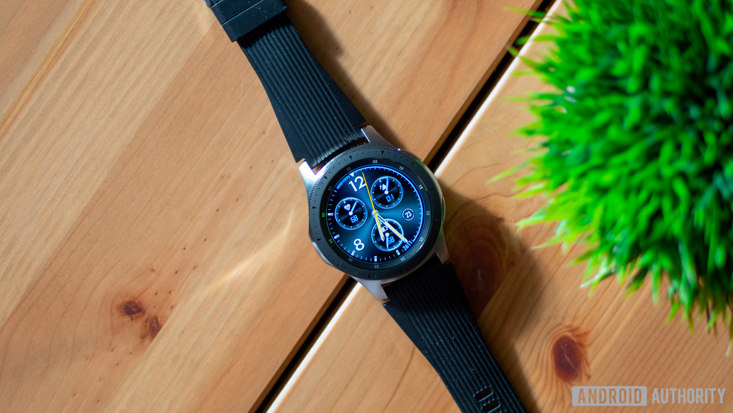samsung galaxy watch on wooden table