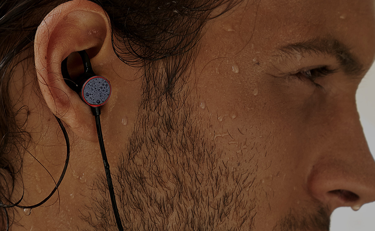An image of a man wearing OnePlus Bullets Wireless earbuds.