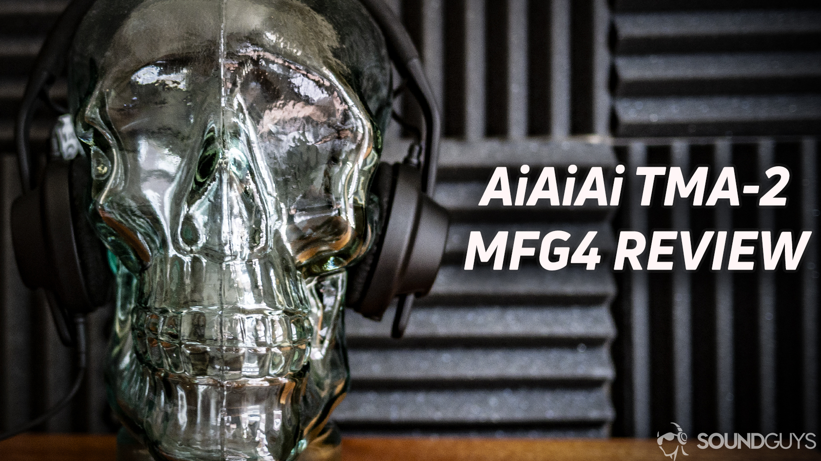 A photo of the AIAIAI TMA-2 MFG4 resting on a glass skull, in front of acoustic foam.