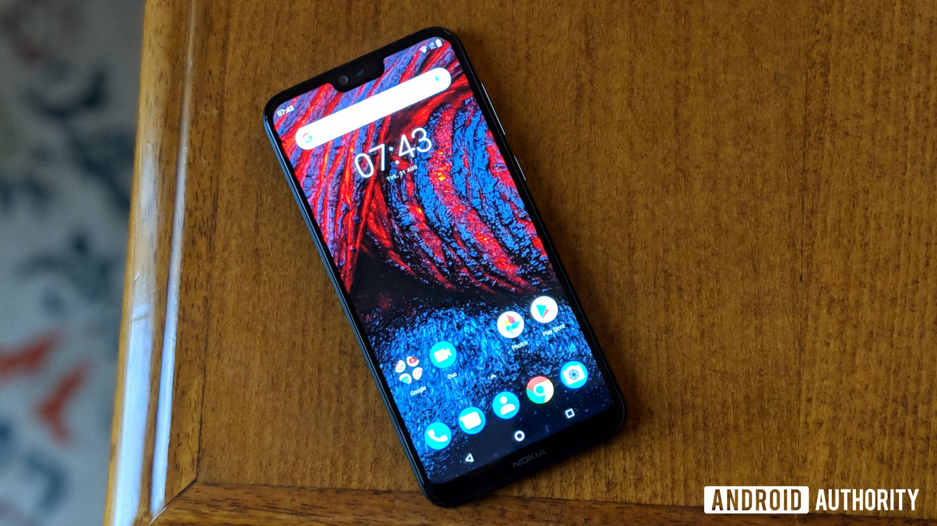 Front side of the Nokia 6.1 Plus layed on a desk.