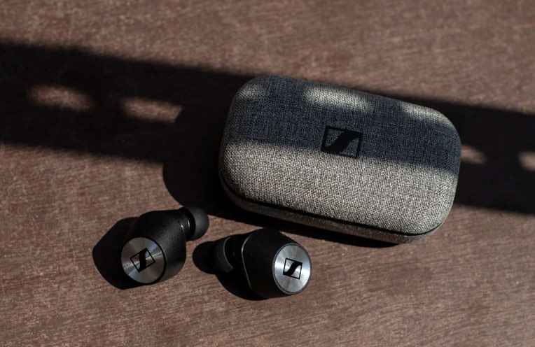Sennheiser Momentum True Wireless press release image of the earbuds next to the charging case.