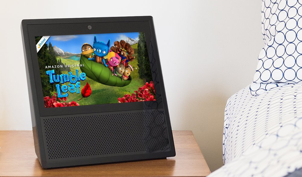 An image of an Amazon Echo Show on a night stand.