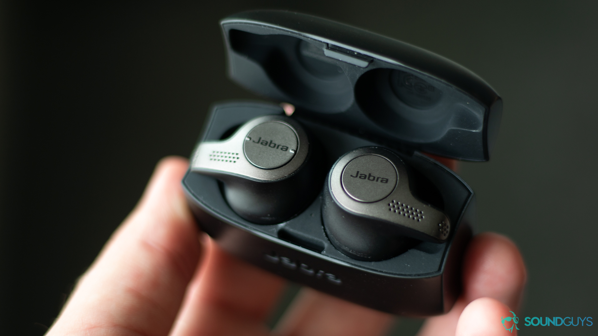 The Jabra Elite 65t in Adam Molina's hand. He holds the carrying case that the earbuds are resting in.