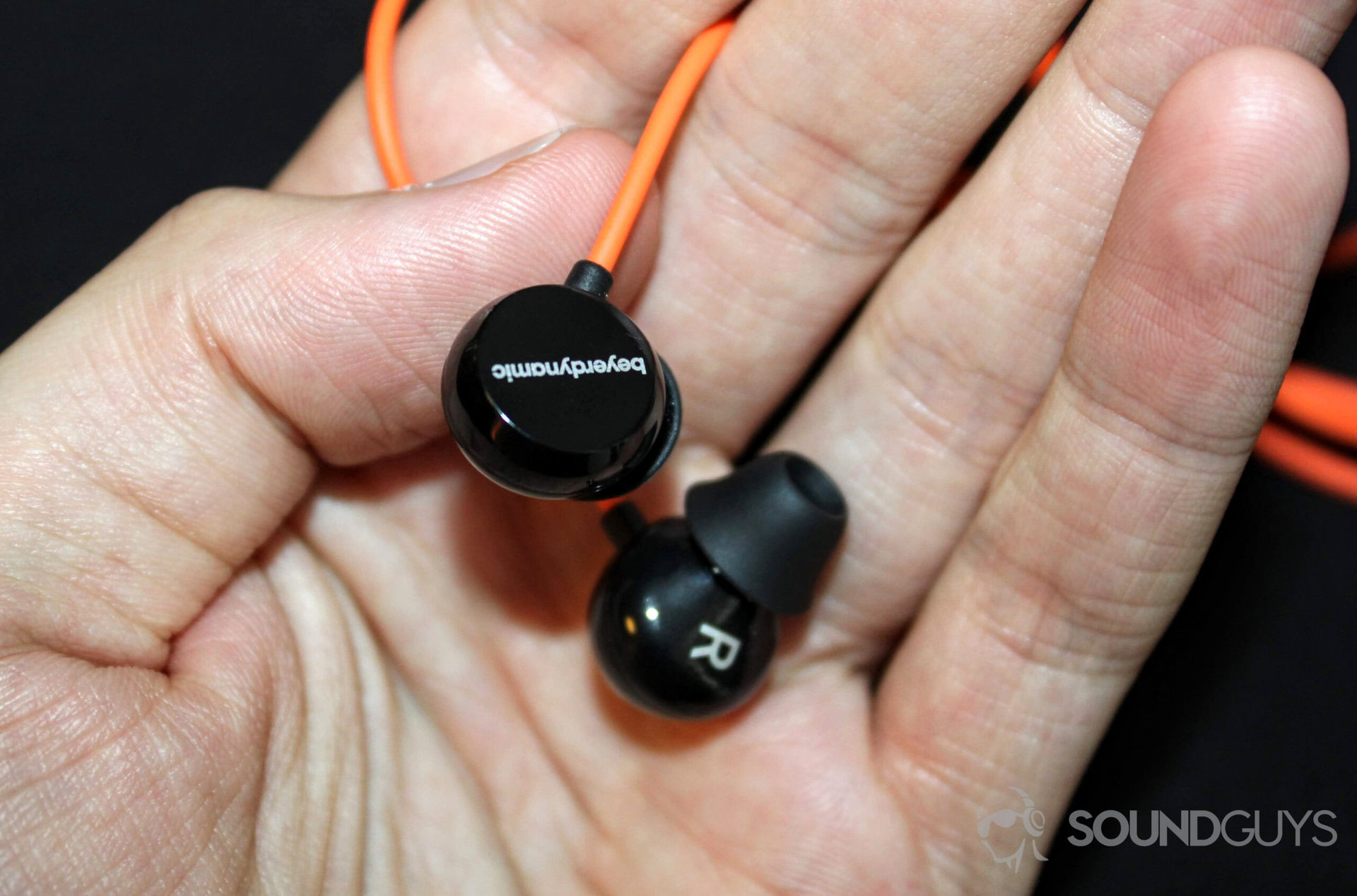 beyerdynamic headphones in a person's hand.