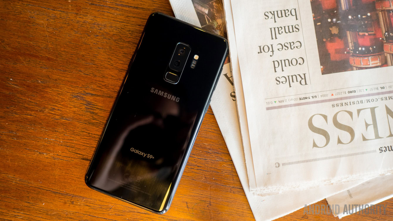 The Samsung Galaxy S9 Plus face down on a wooden table. 