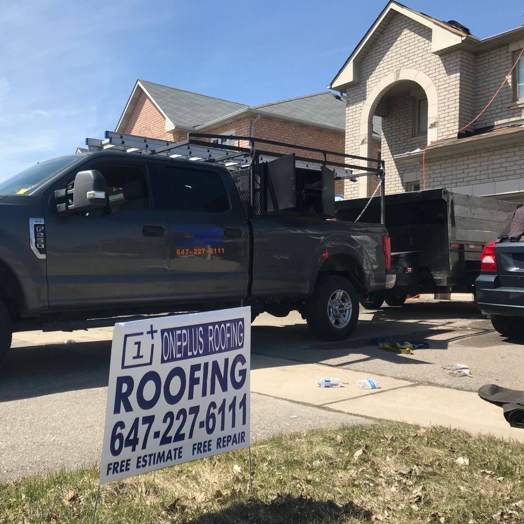 A sign promoting OnePlus Roofing, a company in Toronto that has co-opted the OnePlus logo as its own.