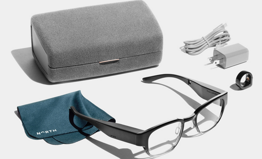 A promotional photo of the Focals smart glasses with all its accessories.
