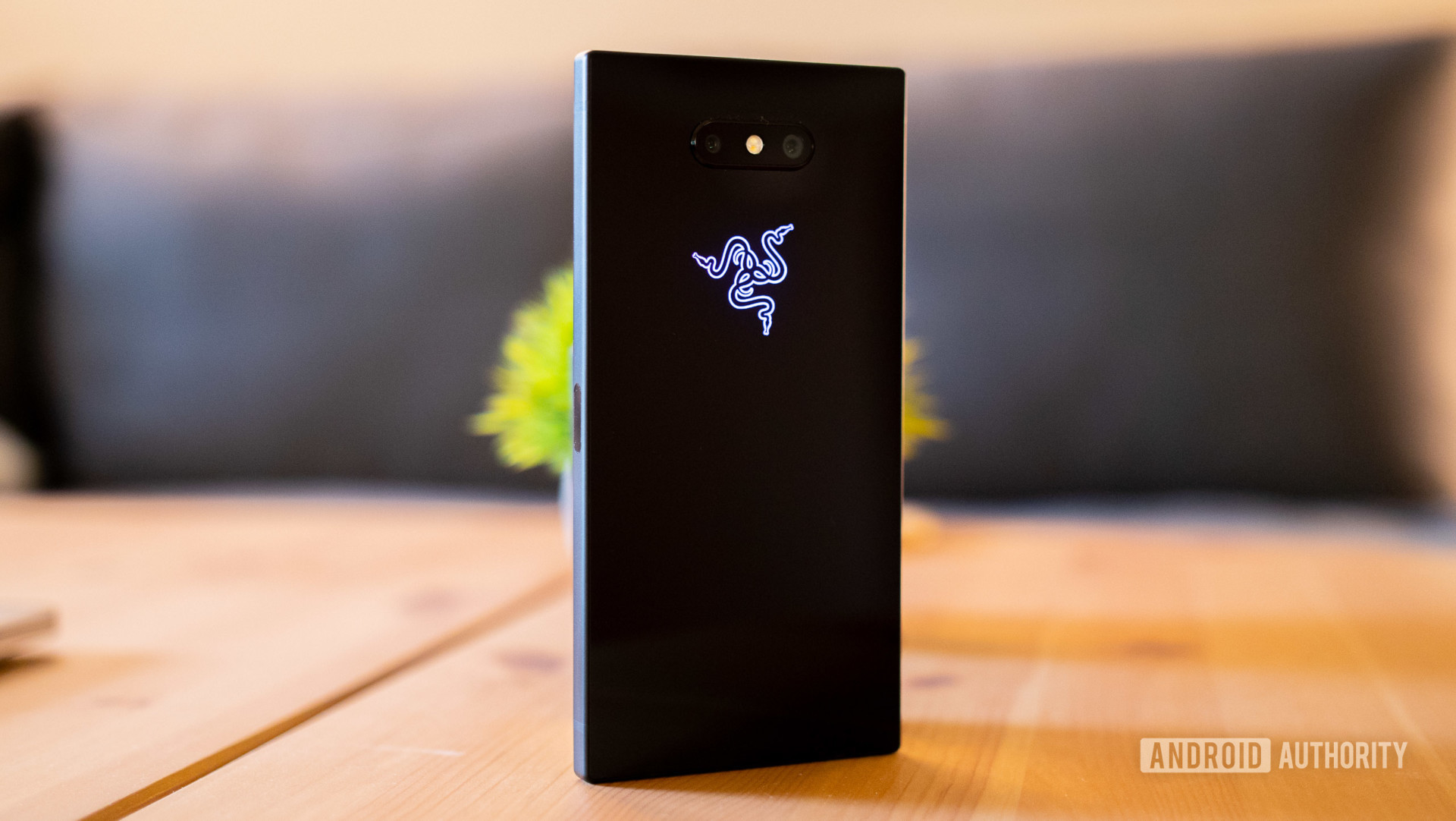 The Razer Phone 2 shot from behind on a wooden surface. 