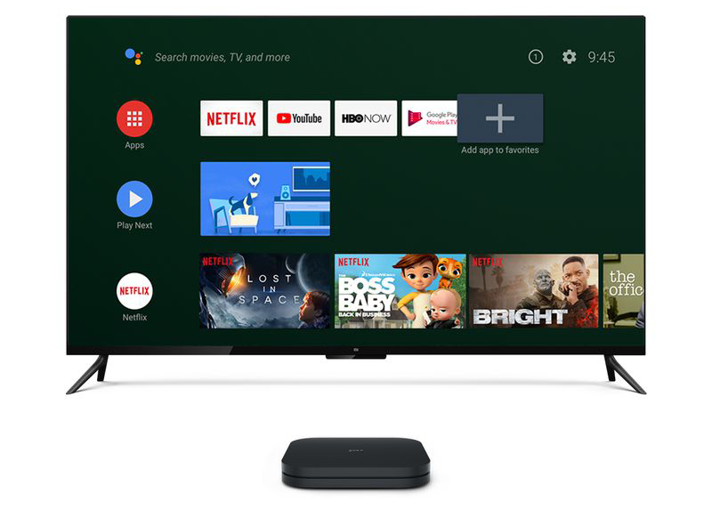 A promotional image of the Xiaomi Mi Box S in front of a flat screen television.