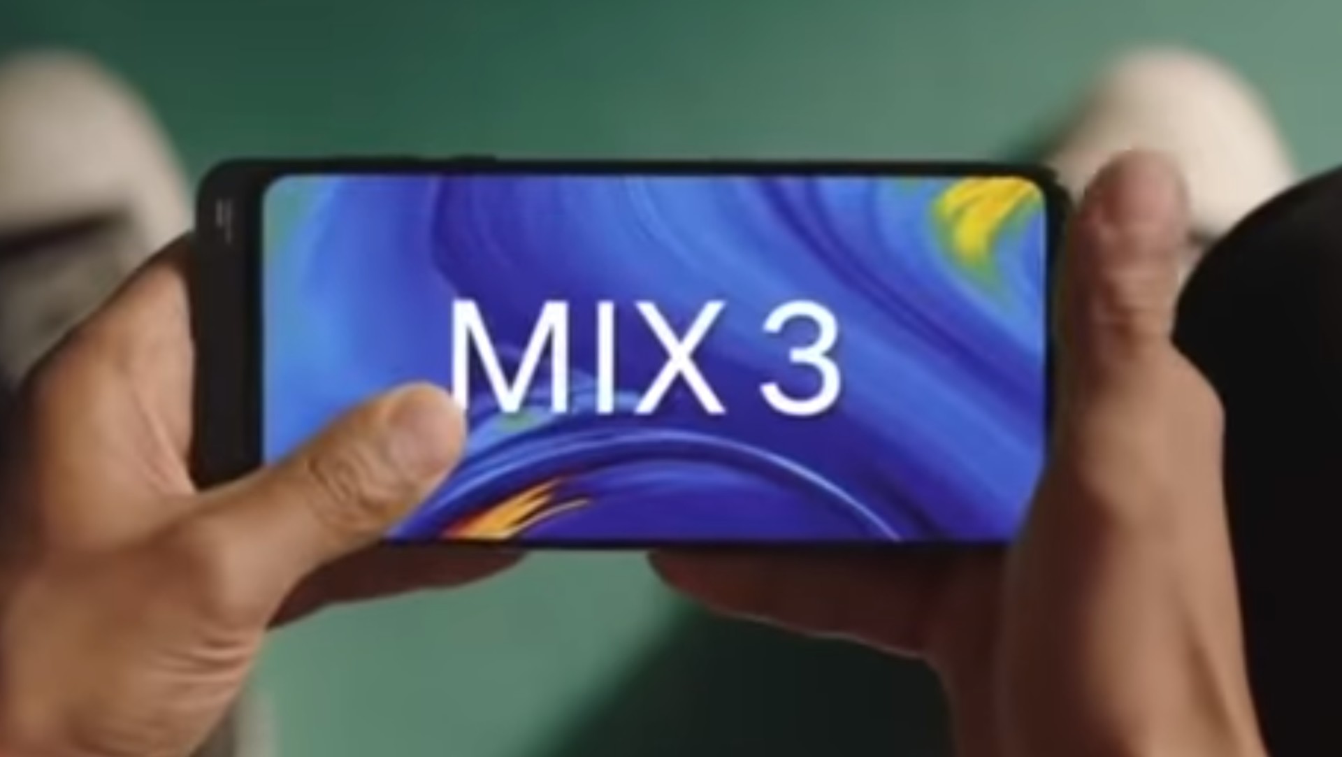 The Xiaomi Mi Mix 3 in a person's hand.