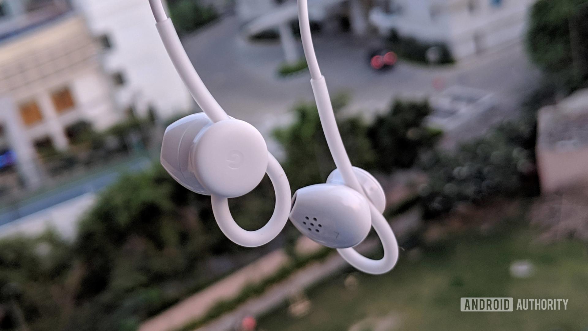 A pair of dangling Pixel USB-C earburds.