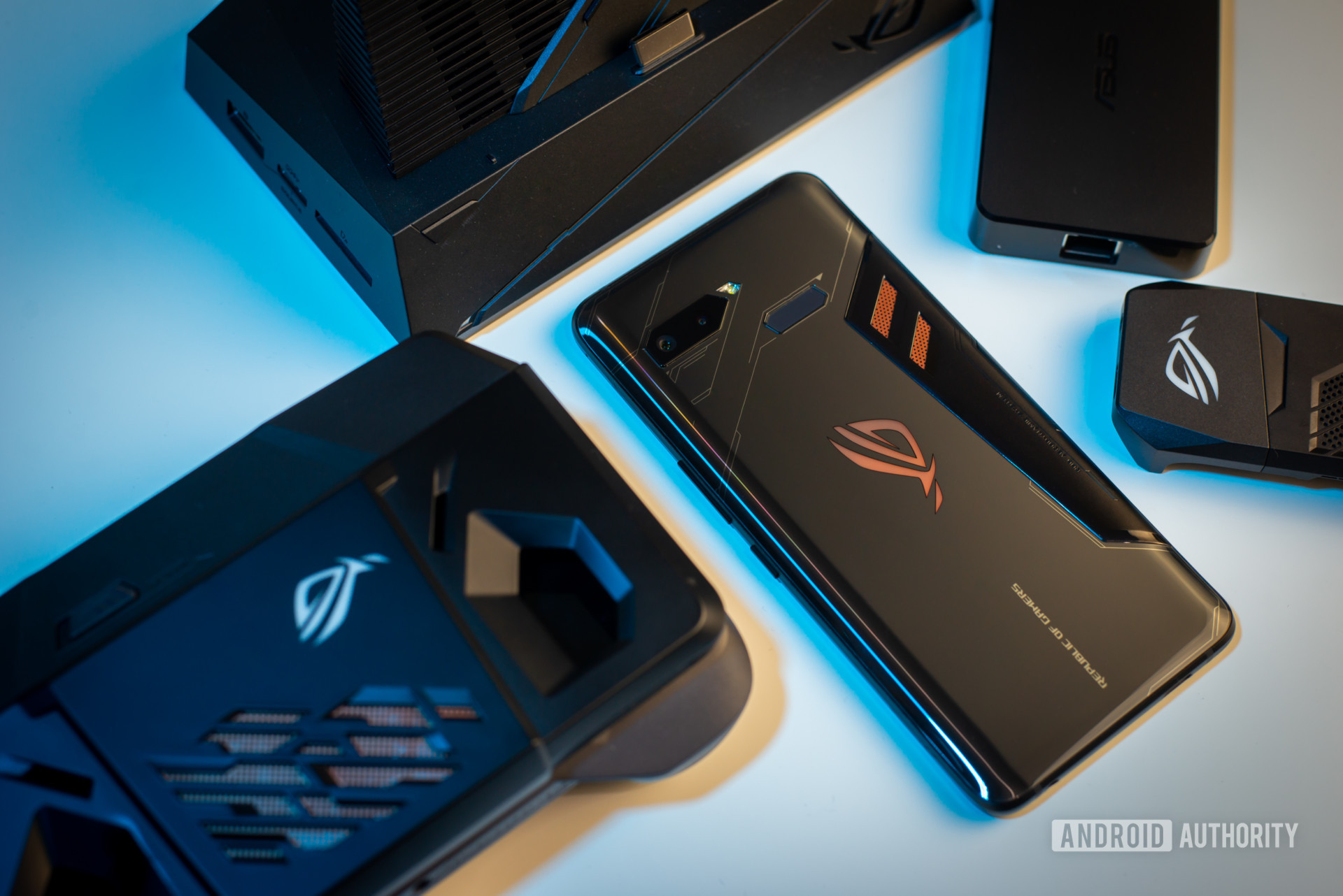 Asus ROG Phone next to gaming accessories. 