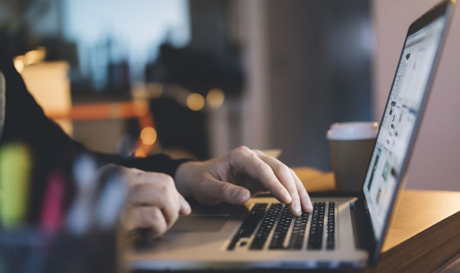 Man Typing on Laptop