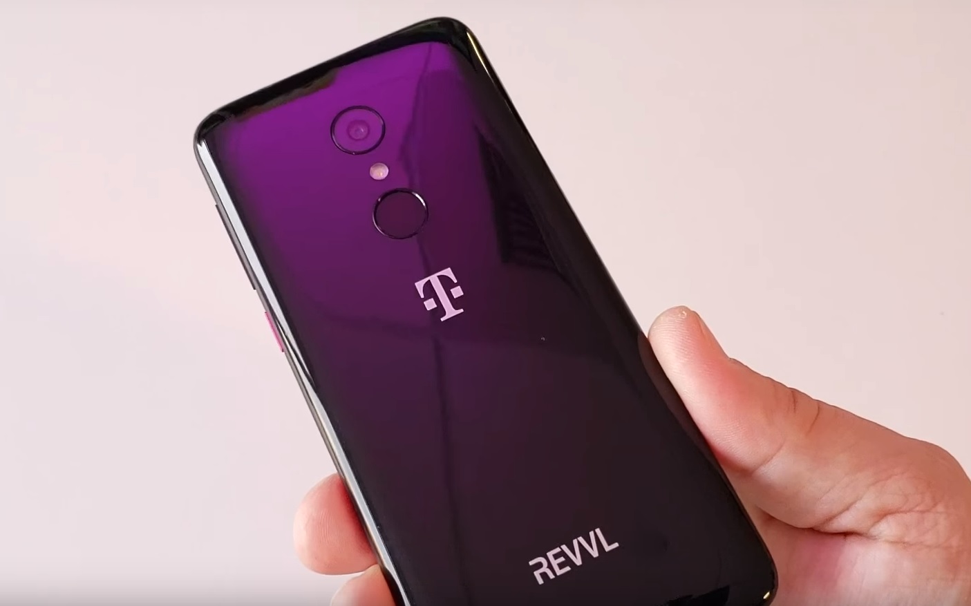A hand holding the T-Mobile Revvl 2, showing the back of the device.
