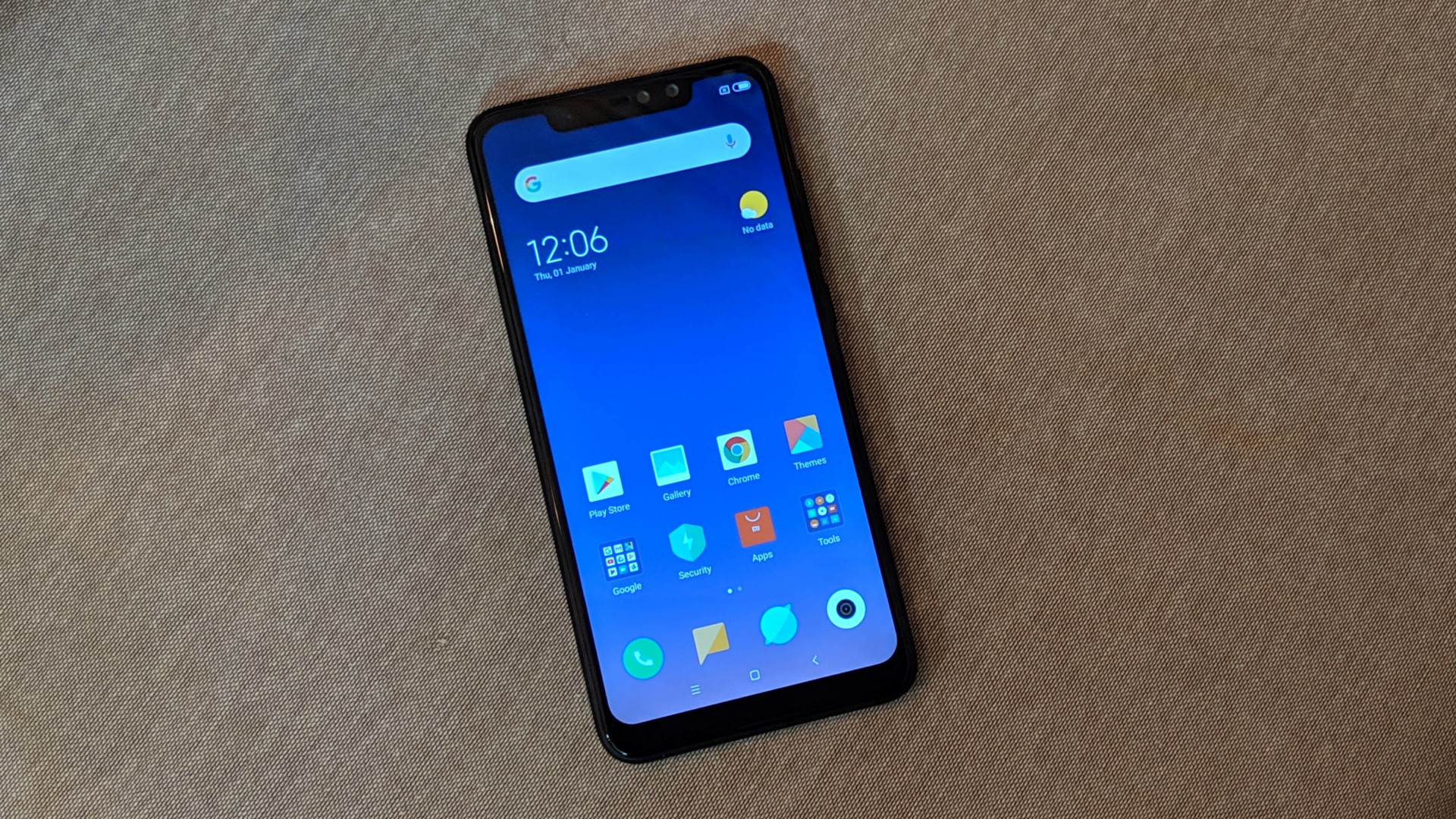 Frontside of a black Redmi Note 6 Pro with a turned on display with a notch