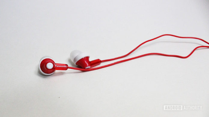 Cheap earbuds: Red Panasonic Ergo Fit on white table.