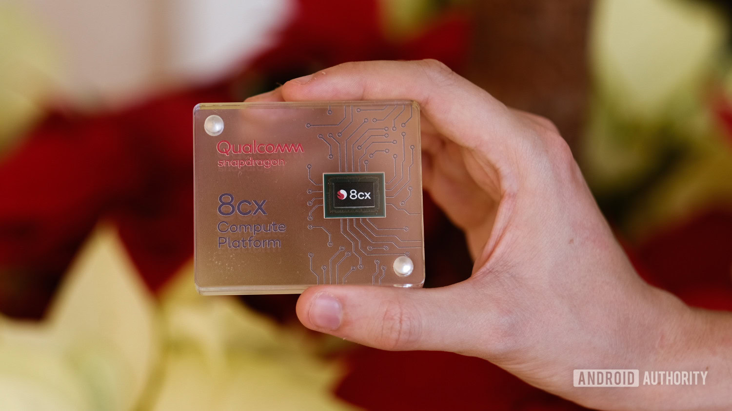 qualcomm 8cx processor held in hand