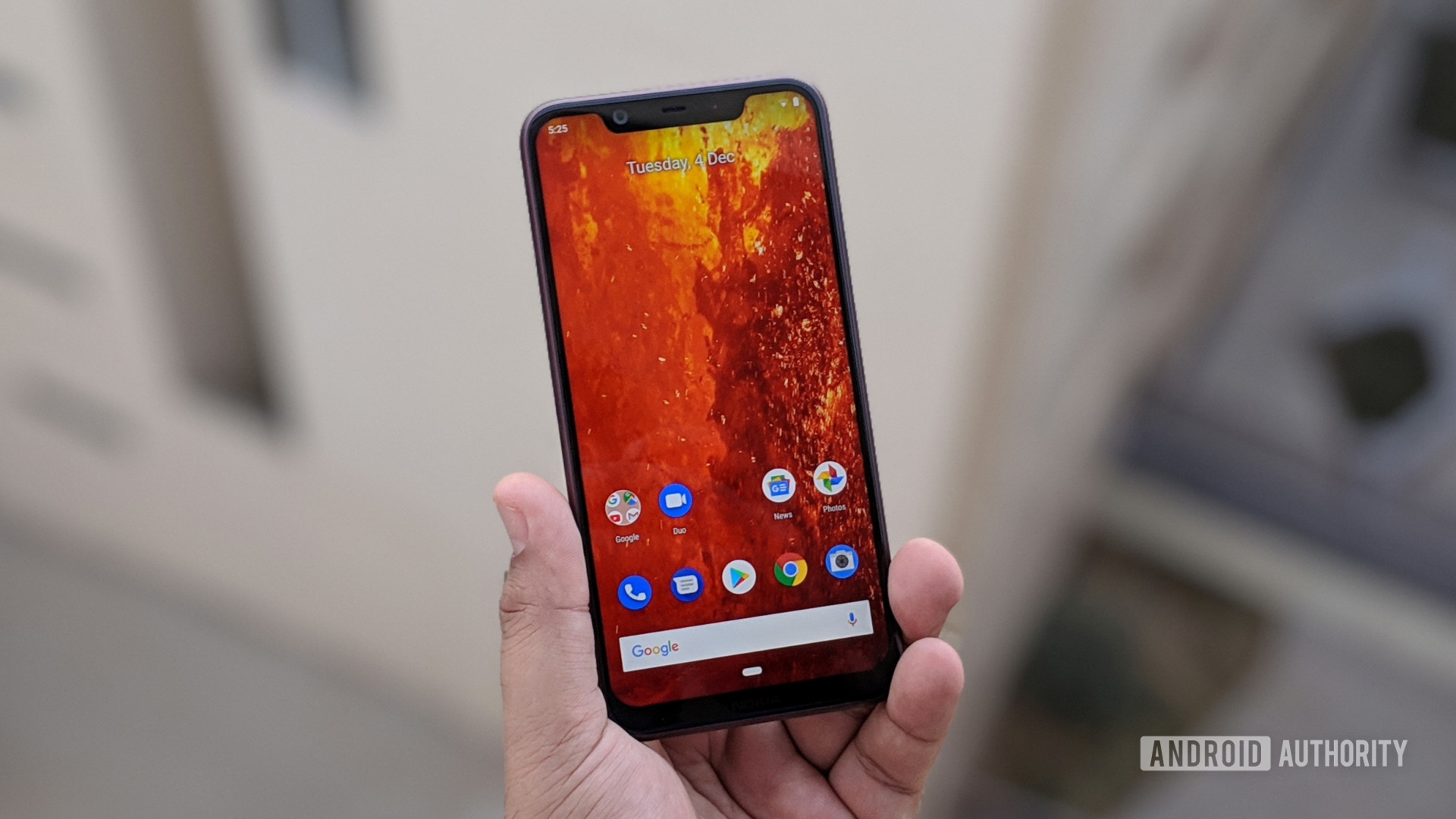 The Nokia 8.1 in a person's hand with a firey wallpaper.