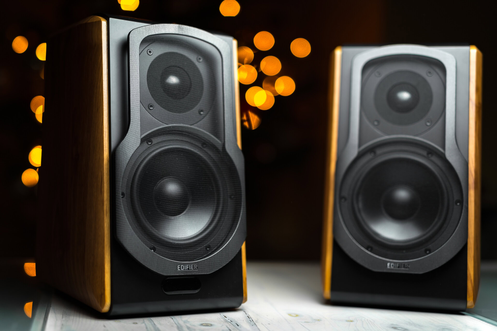 Hero image of the Edifier S1000A smart bookshelf speakers with Alexa. Orange bokeh in the background.