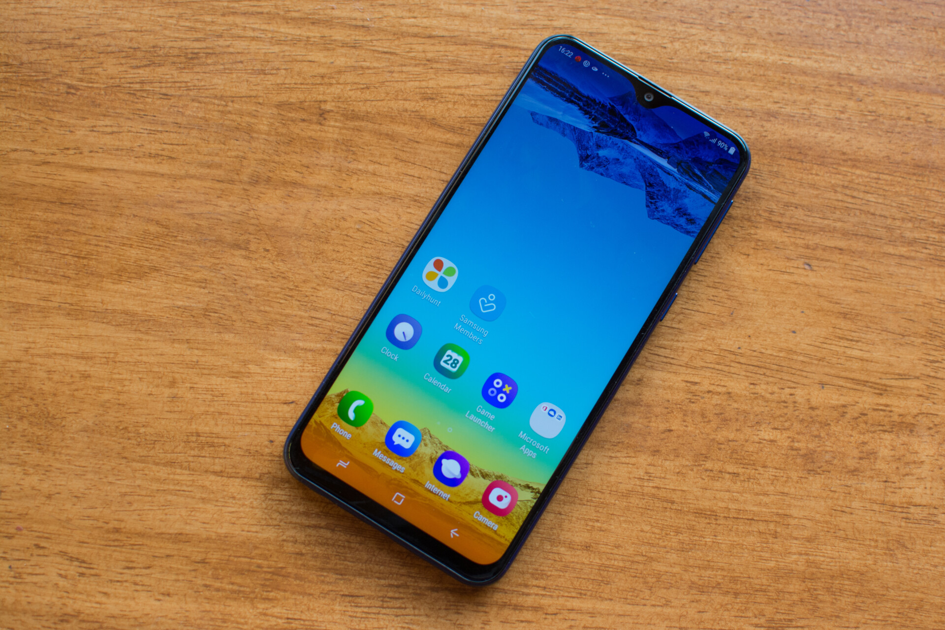 Front side of the Samsung Galaxy M20 with the screen turned on featuring a teardrop notch.