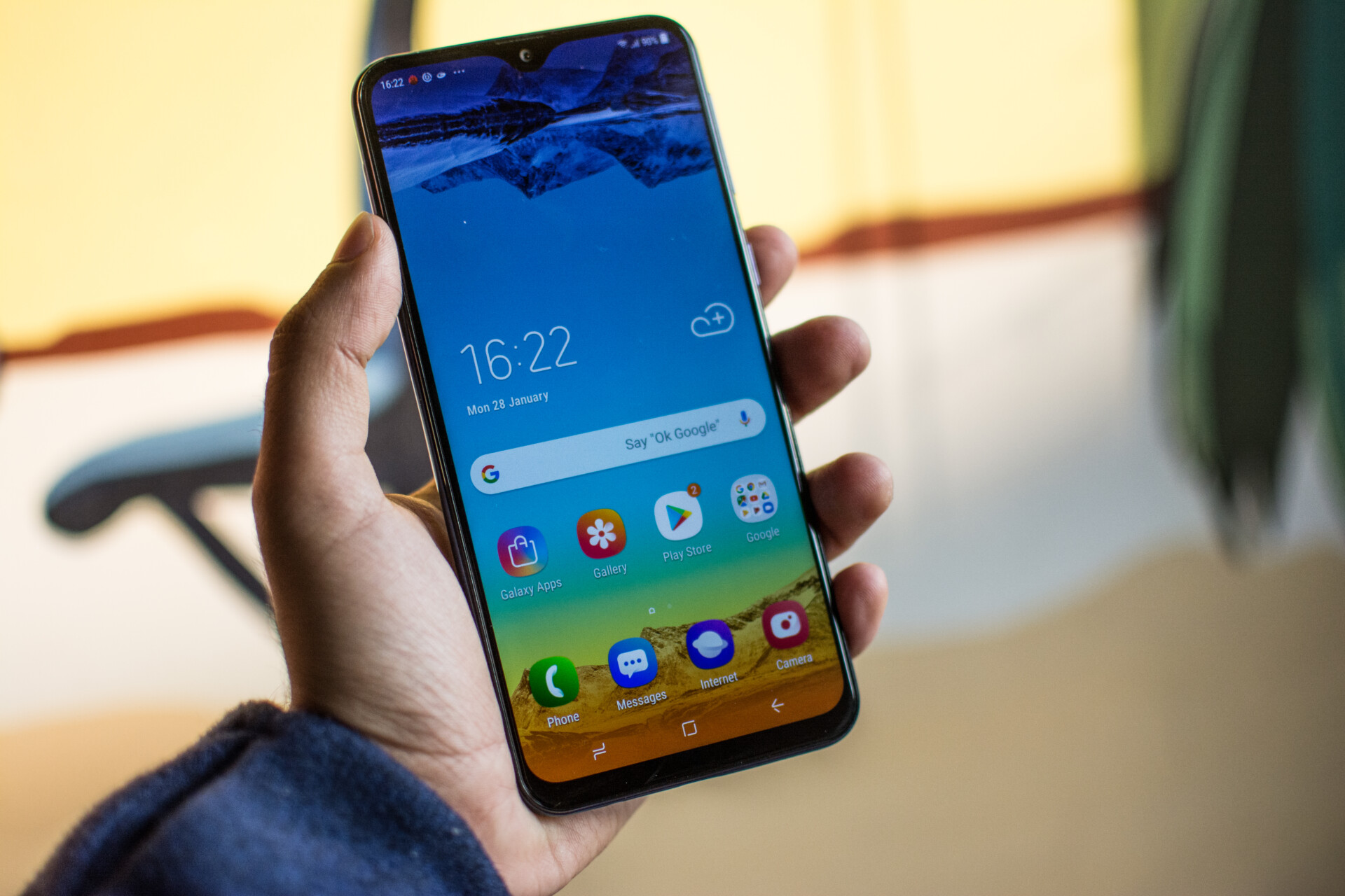 Samsung Galaxy M10 front side held in hand